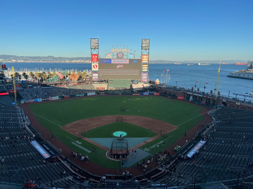 MLB - Oracle Park in San Francisco pictured from the upper deck in left  field. McCovey Cove and the San Francisco Bay are visible beyond right  field.